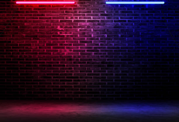 Black brick wall background rough concrete with neon lights and glowing lights. Lighting effect pink and blue on empty brick wall background