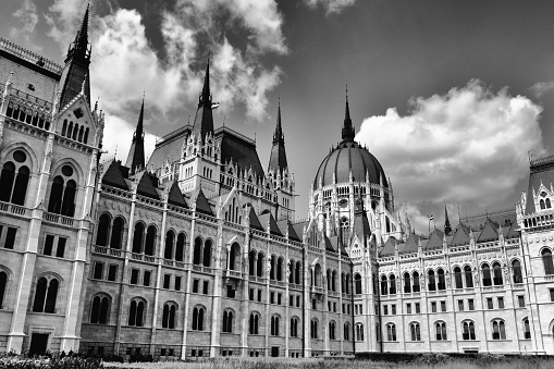 exterior closeup view of the Hungarian Parliament in Budapest in black and white. stone building in neo gothic style. popular travel destination and landmark building. european tourism and travel destination.
