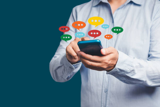 istock Close-up of hands using mobile phone with colorful chat icons on application communication digital web and social media 1649881265