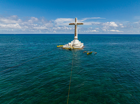 Sunken Cemetery in Camiguin Island. Group of boat floating over the sea. Philippines.
