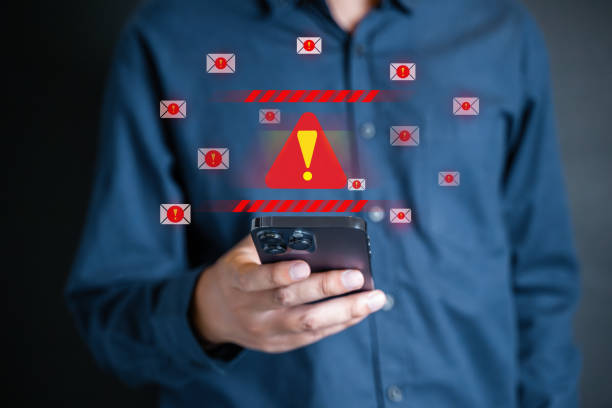 istock People with warning notification and spam message icon on laptop. 1649928090