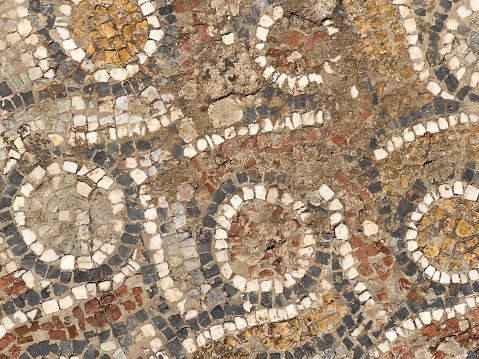 Ancient natural stone tile mosaics with geometric patterns in Ephesus, Turkey. UNESCO world heritage site