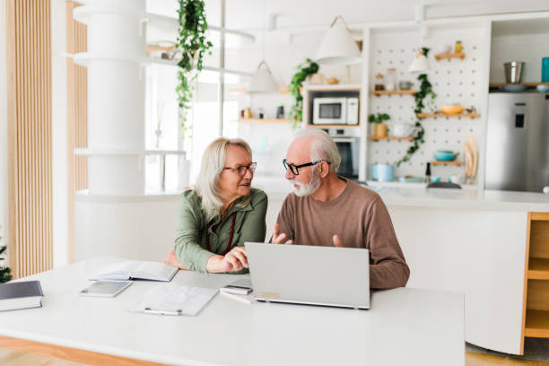 istock Senior couple using laptop while planning their home budget, 1649950957