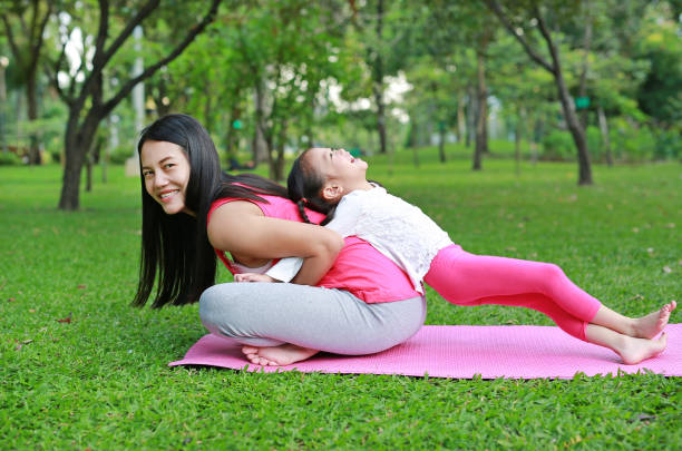istock Asian mother and her daughter doing exercise in the public park. 1649957963