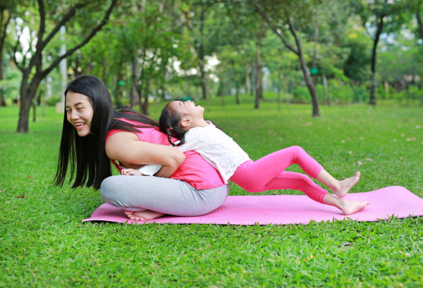istock Asian mother and her daughter doing exercise in the public park. 1649957965
