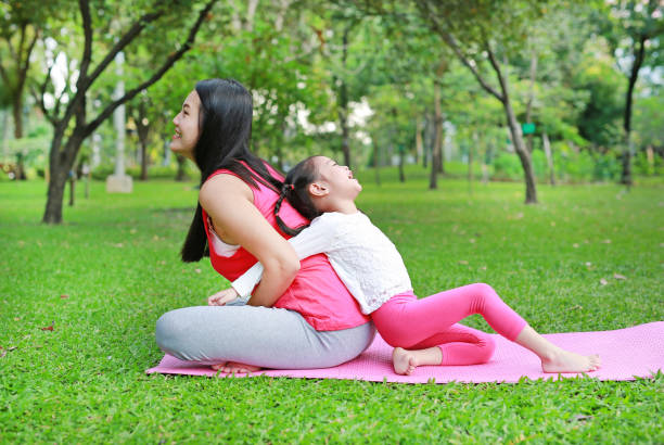 istock Asian mother and her daughter doing exercise in the public park. 1649957985