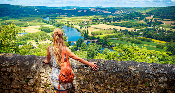 Woman traveling in Europe- Panoramic view of Dordogne river landscape- Nouvelle Aquitaine