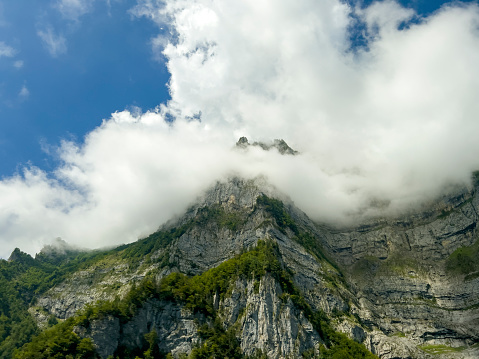 Mountain peak coming out from clouds during trekking in Julian Alps, Slovenia.