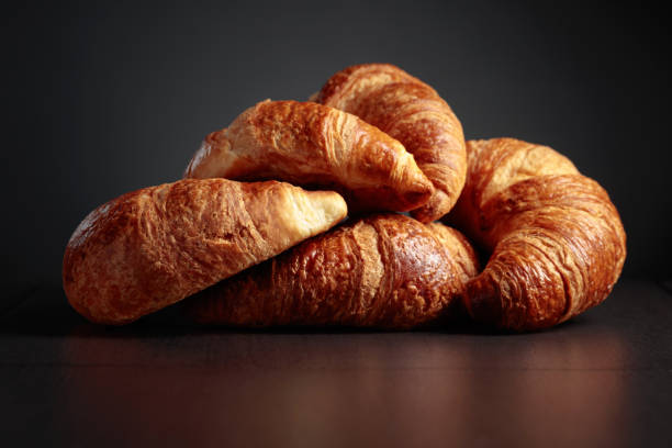 istock Freshly baked croissants on a black ceramic table. 1649978032
