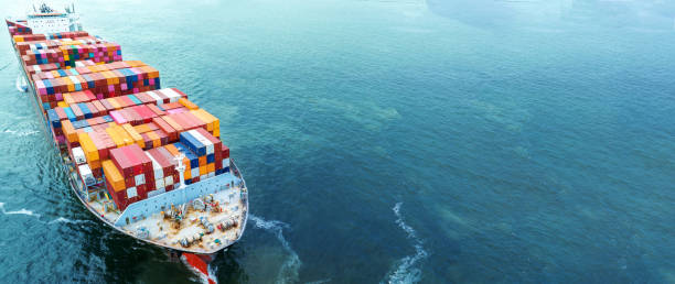 istock Aerial side view of cargo container ship carrying container from custom container depot go to ocean concept freight shipping by ship service on blue sky .Freight Forwarding Service 1650032057