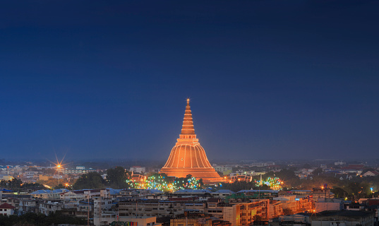 Large golden pagoda located in the community at sunset, Phra Pathom Chedi , Nakhon Pathom , Thailand