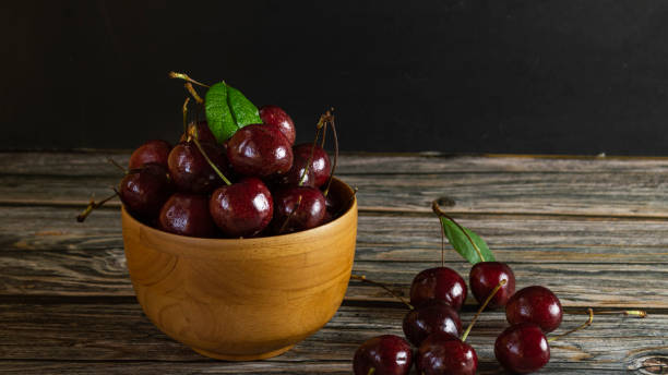 istock Fresh cherry, red fruit in a wooden cup 1650059730