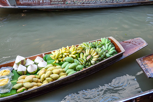 Fruit and local food sell on boat at floating  market, Thailand