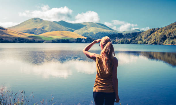 istock Woman enjoying beautiful lake ( Guery lake, Auvergne in France) 1650085699