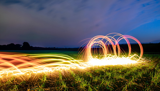 Running down a field creating light painting