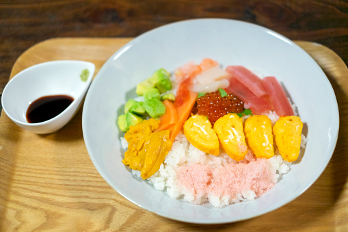 Chirashi Zushi. rice topped with sashimi and other ingredients.