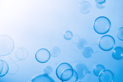 Beautiful Transparent Blue Soap Bubbles Floating in The Air. White Space, Abstract Background, Blue Gradient Blurred Background, Refreshing of Soap Suds Bubbles Water.