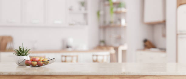 istock Mockup space on a luxury white marble tabletop with a blurred modern minimal white kitchen 1650125837
