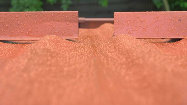 istock Rain Hitting Modern House Roof Tiles during Thunderstorm Water Drops Close Up 1650135527
