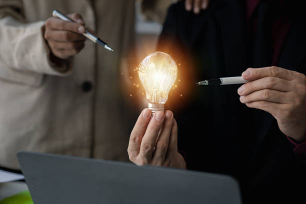 istock Businessman holds a glowing lamp, Creative new idea. Innovation, brainstorming, strategizing to make the business grow and be profitable. Concept execution, strategy planning and profit management. 1650143099