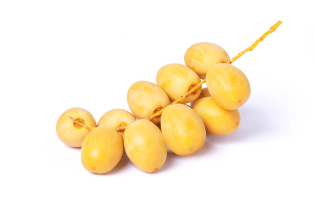 Fresh yellow date palm fruit isolated on white background with clipping path.