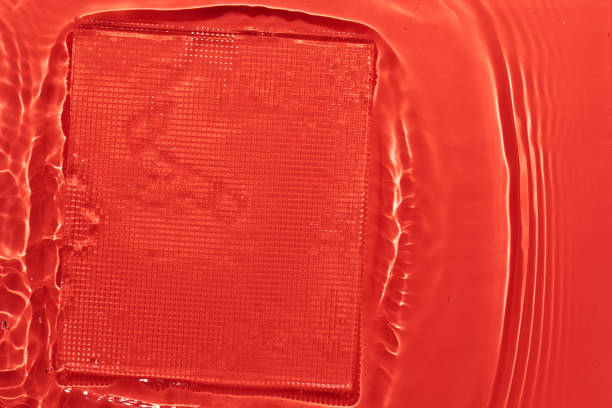 Water red surface abstract background. Waves and ripples texture of cosmetic aqua moisturizer with bubbles