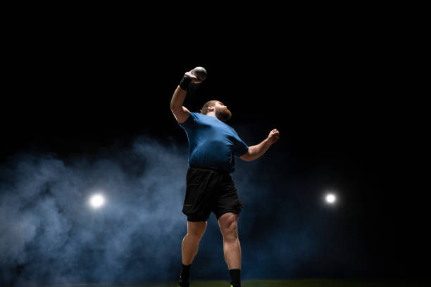 istock Male athlete throwing shot put ball 1650168401