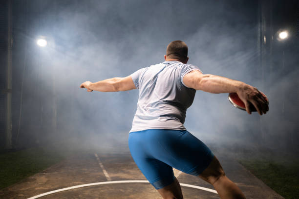 istock Male athlete holding discuss 1650168420
