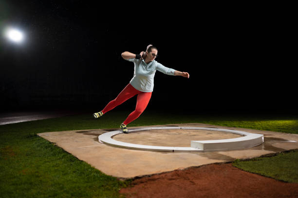 istock Female athlete throwing shot put ball 1650168438