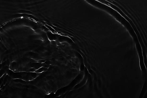 istock Water black surface abstract background. Waves and ripples texture of cosmetic aqua moisturizer with bubbles 1650168460