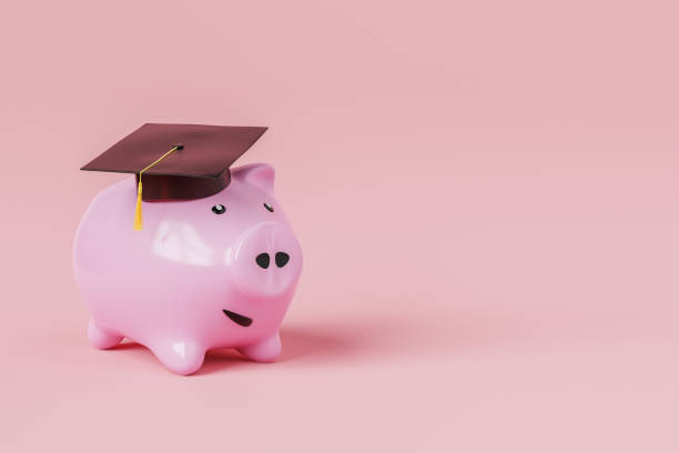 istock Piggy bank with black graduation hat 1650168545