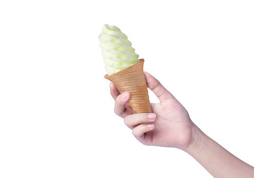 Hand hold biscuit green vanilla soft ice cream cone isolated on white background.