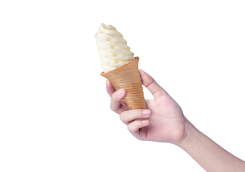 Woman hand holding waffle pink soft vanilla ice cream cone isolated on white background.