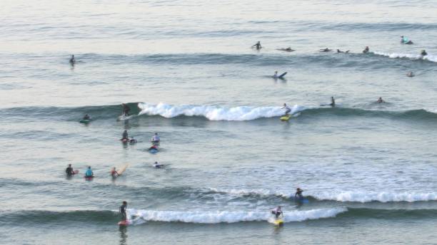 istock Anonymous Surfers Surfing Small Waves on Atlantic Ocean in Morocco 1650176736