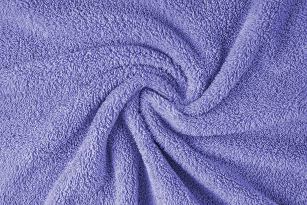 istock Terry cloth, purple towel texture background. Soft fluffy textile bath or beach towel material 1650194323