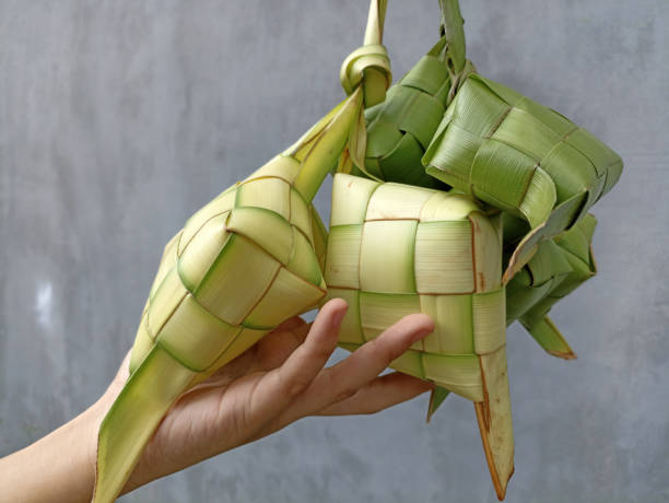 istock Person holding Ketupat (Rice Dumpling) in hand. 1650197575