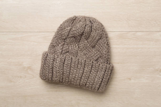 istock Grey winter hat on wooden background. Top view 1650214369