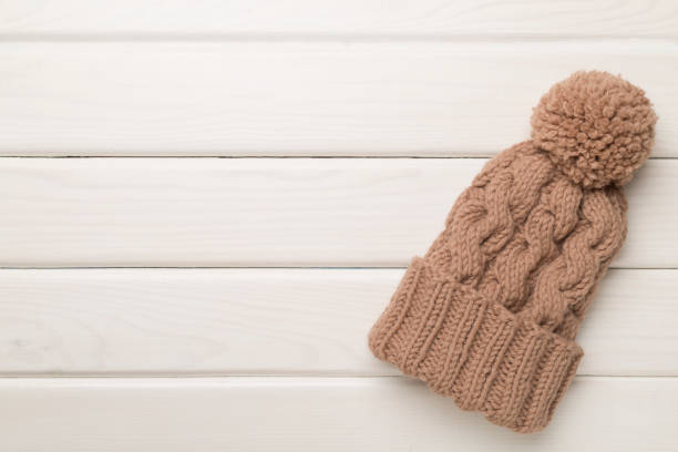istock Brown winter hat on wooden background. Top view 1650214879