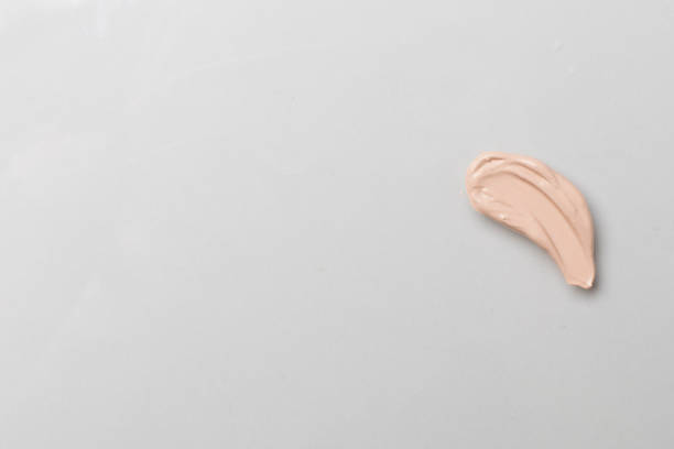 istock Foundation smudge on color background, top view 1650218805