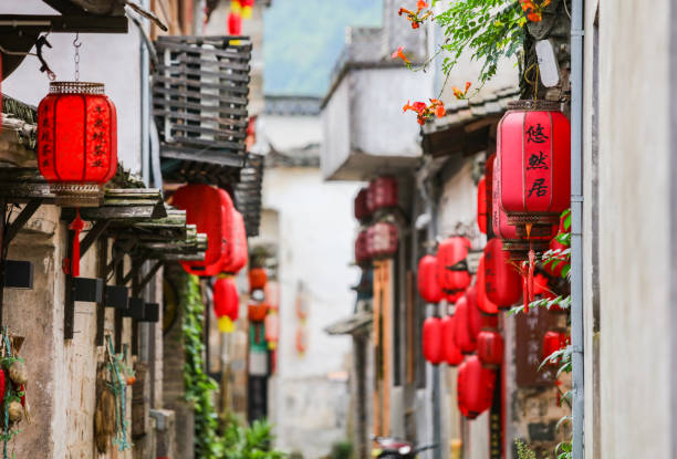 Red lanterns hang on the narrow streets of the ancient village of Xidi, Anhui, China Anhui China July 19, 2021, Red lanterns hang on the narrow streets of the ancient village of Xidi huangshan mountains stock pictures, royalty-free photos & images