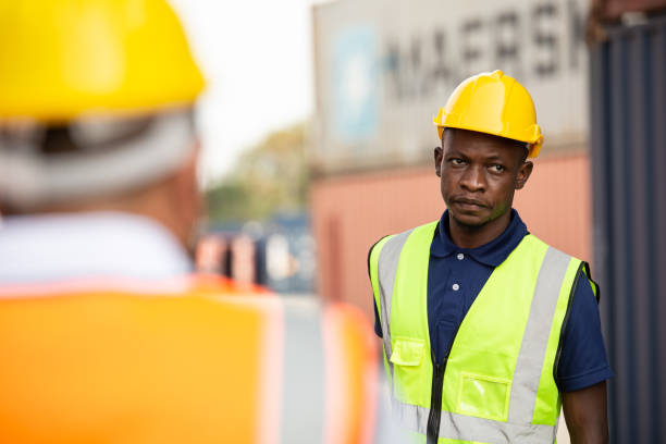 istock African male contractor worker standing at container warehouse or construction factory. Labor employee career concept 1650228914