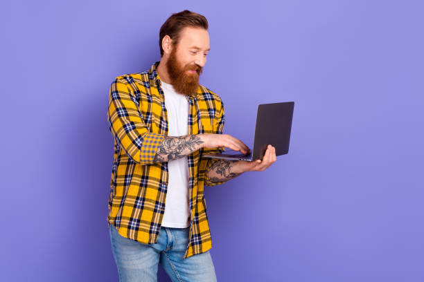 istock Portrait of nice man use wireless netbook microsoft apple empty space ad isolated on purple color background 1650229525