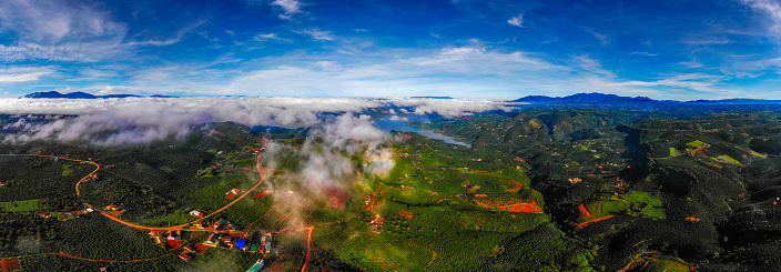 Aerial photo of coffee covered in mist, beautiful landscape of Lam Ha, Lam Dong, Vietnam with lake, coffee hill, white mist covering the coffee hill