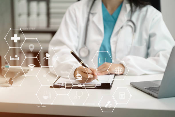 istock Doctor working with laptop computer and writing on paperwork. in the room. 1650236331