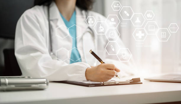 istock Doctor working with laptop computer and writing on paperwork. in the room. 1650236349