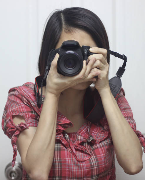 istock A woman is holding her camera and take a picture 1650242990