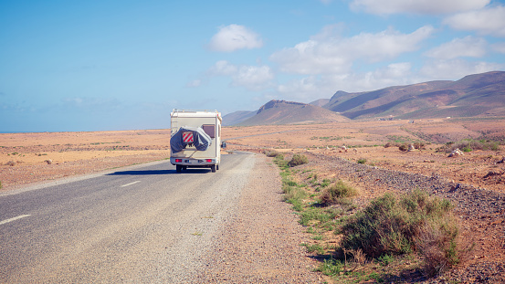 road trip in motorhome in desert landscape-  travel destination, adventure, wanderlust concept