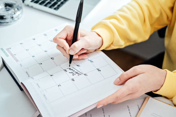 istock Planner calendar with text Job interview on date. Female hands writing Job Interview Date on a Calendar. Woman write in print calendar with mark and job interview words 1650284905