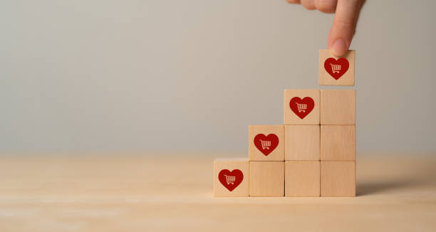 istock Customer engagement, increasing customer loyalty concept. Building relationships, increase brand awareness, and drive sales. Wooden cube blocks with red hearts and customer loyalty icon on background. 1650289344