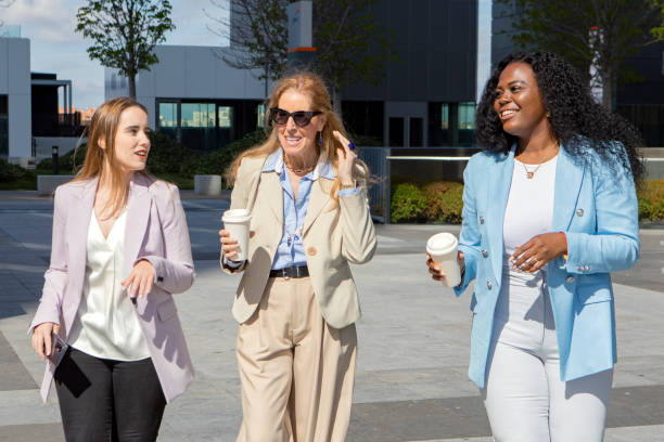 istock Three businesswomen talking while walking together outdoors in the financial district. Business concept. 1650290689